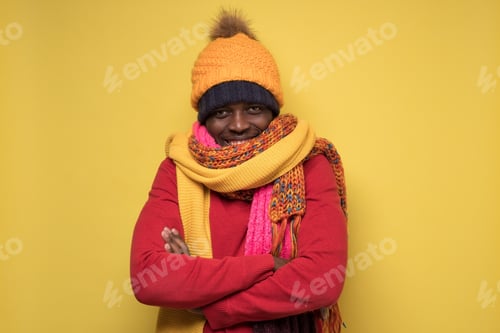 Preview: African man in several scarfs and hats smiling brightly at camera