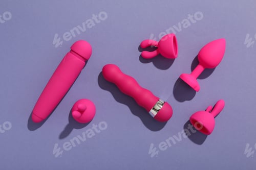 Preview: A collection of sex toys on a purple background.