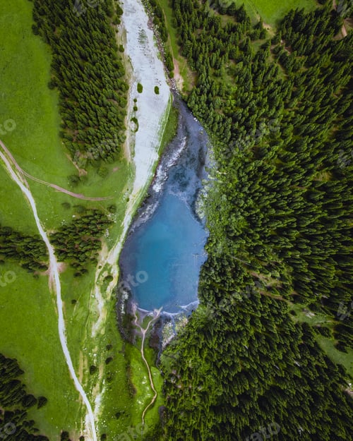 Preview: Top-down view of turquoise mountain lake and forest
