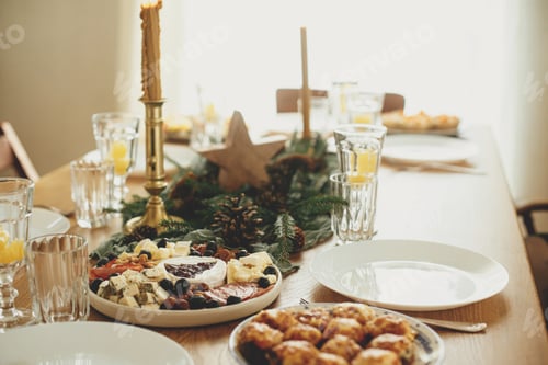 Preview: Christmas table setting. Modern cheese platter with cranberry sauce as christmas tree, fir branches