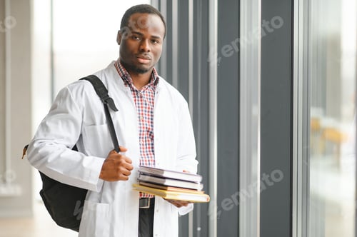 Preview: Young Professional Doctor with Books in Office