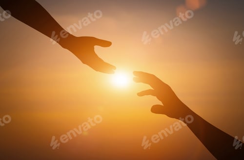 Preview: Silhouette of reaching, giving a helping hand, hope and support each other over sunset background.