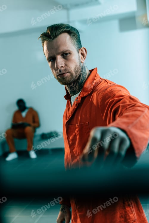Preview: multiethnic prisoners in prison cell behind prison bars