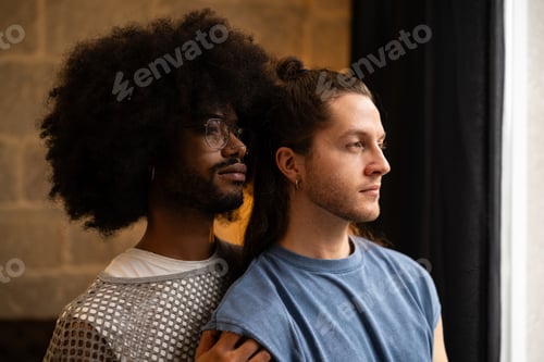 Preview: Lgbtq plus partners hugging tenderly, looking through window with intimacy