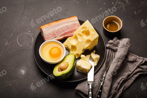 Preview: Foods for keto diet on black plate on dark background copy space