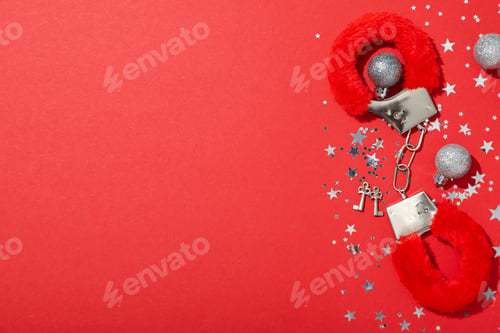 Preview: Sex toy with New Year's decor on a red background.