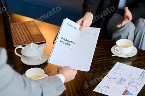 Preview: Close-up of female hand passing financial report to colleague