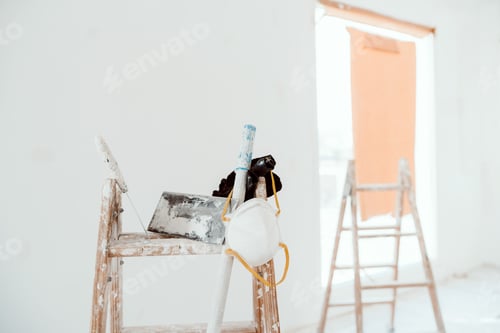 Preview: ladders and tools on white room at construction site. Painting walls. Home improvement, renovation