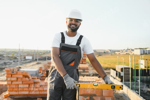 Preview: Indian Construction worker in uniform and safety equipment have job on building