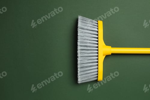 Preview: Plastic broom on dark green background, top view. Space for text