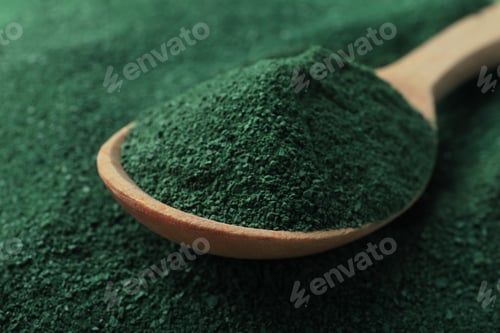 Preview: Spoon of spirulina on green algae powder, closeup