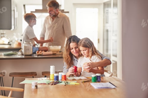 Preview: Mother painting with child and father cooking with kid in their family home together for growth dev