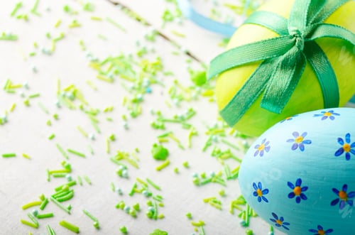 Preview: Painted decorated easter eggs with sprinkles on white table