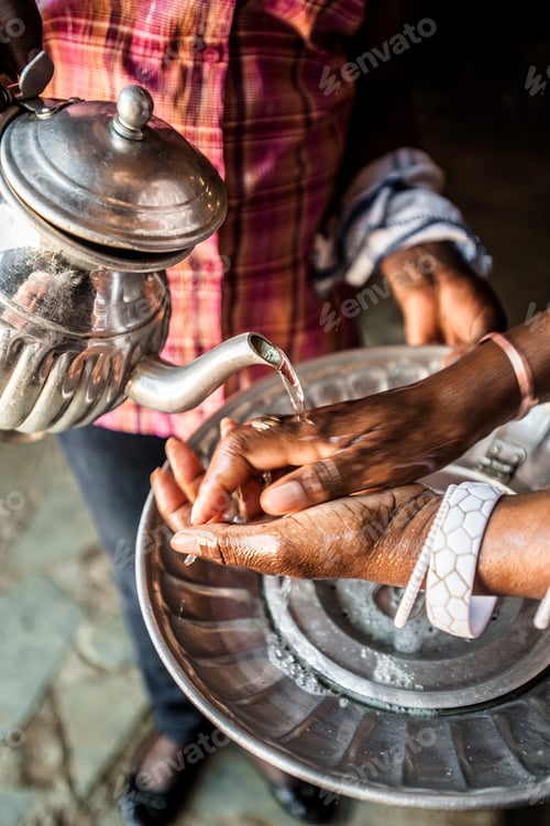Preview: Close up of waiter pouring water on mans hands in restaurant, Katutura, Namibia, Namibia