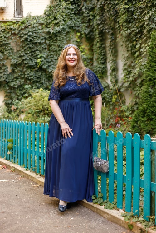 Preview: Woman in a long blue dress in the garden
