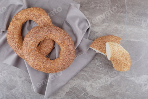 Preview: Crispy bagels on a piece of fabric on marble background