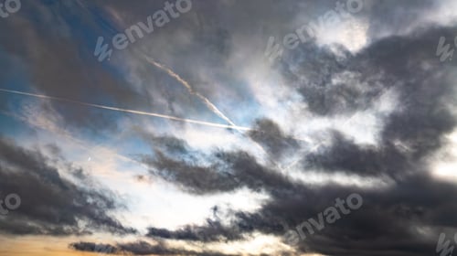 Preview: an airplane with contrails in the sky during a cloudy day