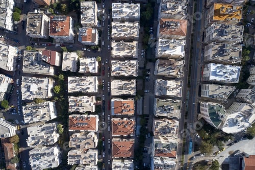 Preview: Top view of roof of multi-storey building with cars traffic on the street.