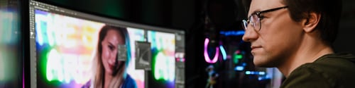 Preview: Back view of a young white man video editor