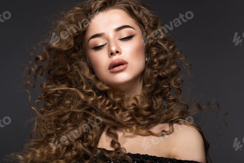 Preview: Beautiful brunette girl in move with a perfectly curly hair, and classic make-up. Beauty face.