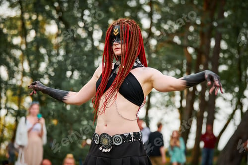 Preview: Mythological dancing girl faun on green lawn in public park outdoor art dancing event