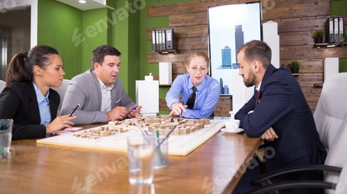 Preview: Middle age female architect in a meeting with real estate developers