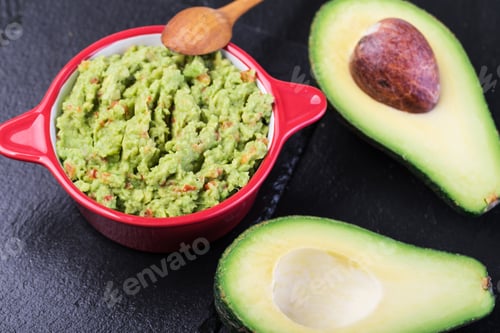 Preview: Guacamole with avocado and wooden spoon on slate