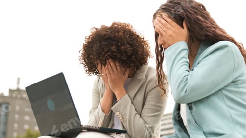 Preview: Sad female entrepreneurs with netbook under sky outdoors