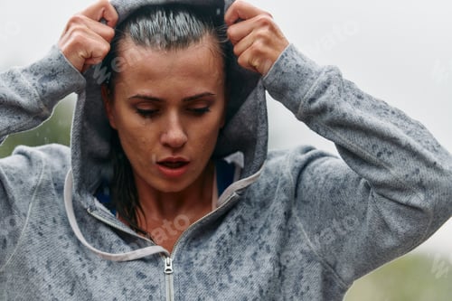 Preview: Woman Resting in the Rain After Intense Run