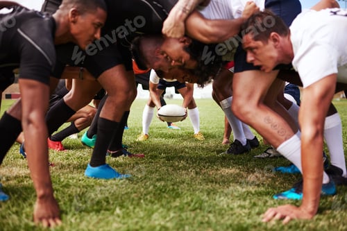 Preview: The battle begins. Shot of a group of young rugby players in a scrum on the field.