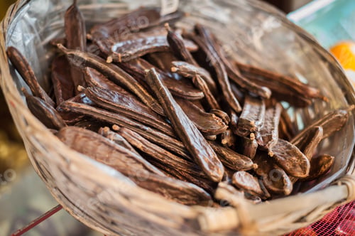 Preview: Carob pods in wicker basket.