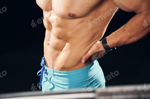 Preview: Athletic man in great shape touching his back