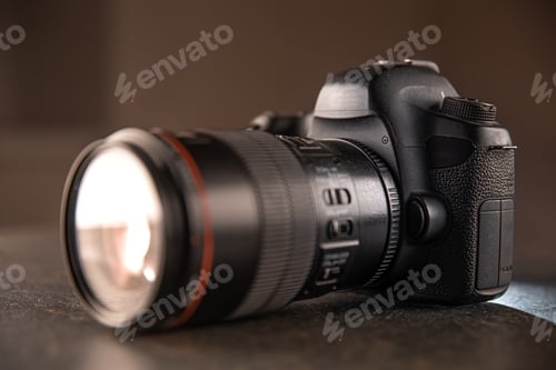 Preview: Close up in focus lens on the body of a professional digital camera.