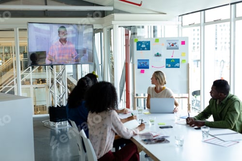 Preview: Diverse business people attending video conference at conference room