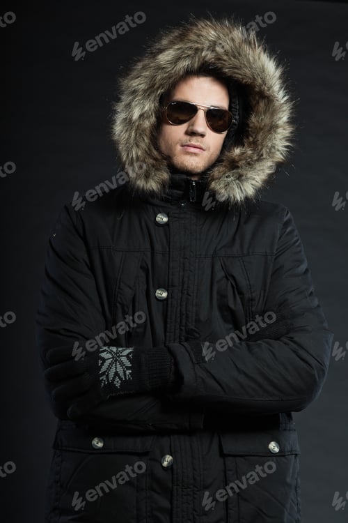 Preview: Handsome Man Dark Winter Fashion. Studio Shot. Wearing Black Hood Jacket And Sunglasses.