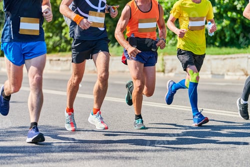 Preview: Marathon runners on city road.