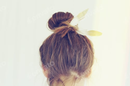 Preview: Rear view female hair in a bun with feather
