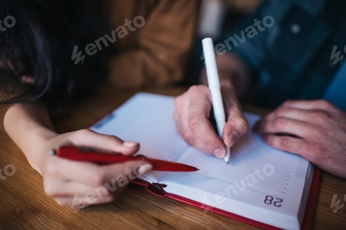 Preview: Smart colleagues planning organisation using education textbook for making information notes