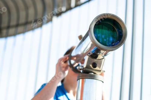 Preview: Woman looking through a telescope