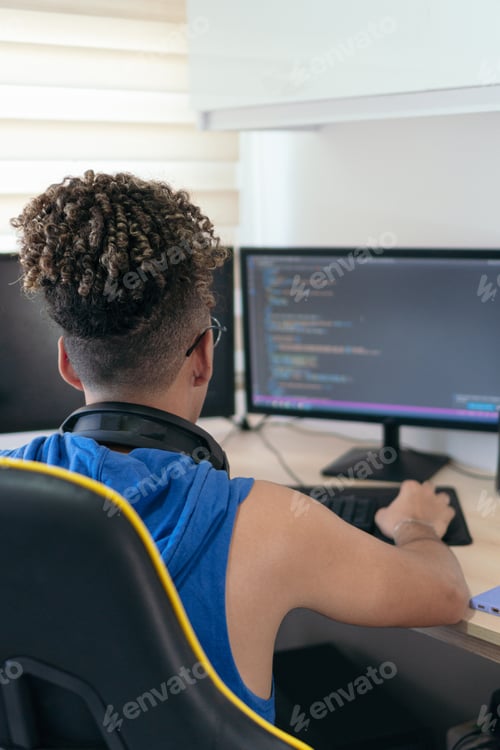 Preview: Computer programmer busy coding in his studio