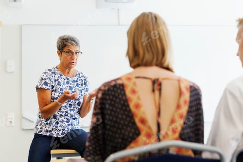 Preview: Engaged discussion in a bright classroom setting.
