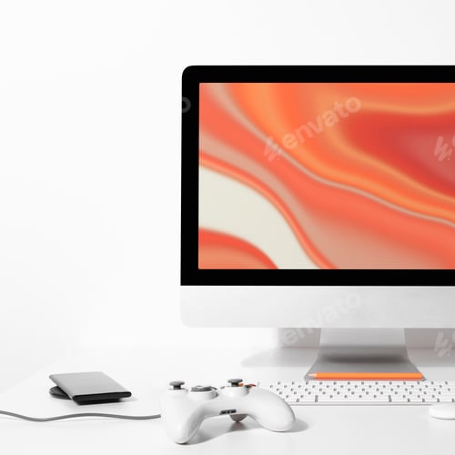 Computer and Gamepad on White Desktop Background