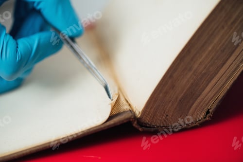 Preview: Conservator Repairing Antique Book in Restoration Laboratory