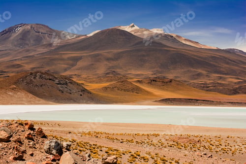 Preview: Picture of a lake against mesmerizing brown mountains under the great sky