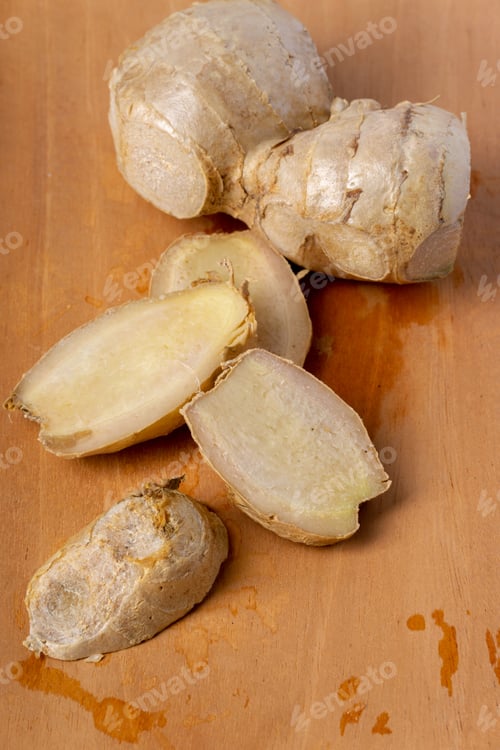 Preview: Ginger slices on cutting board. Top view. Close up.