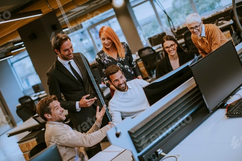 Preview: Senior businesswoman and young business people work in a modern office
