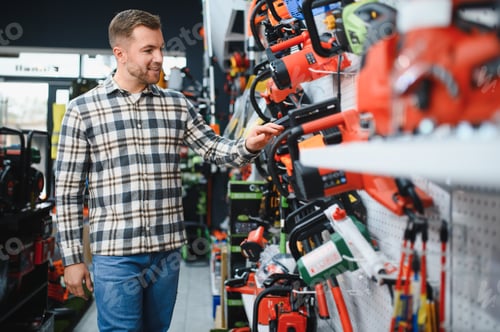 Preview: Man is choosing electric saw in tools store