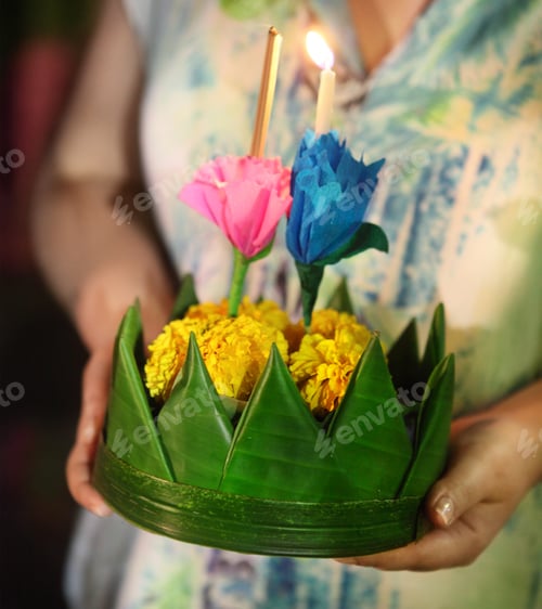 Preview: Woman holding boat with candles and flowers are given for Thailands traditional Loy Krathong