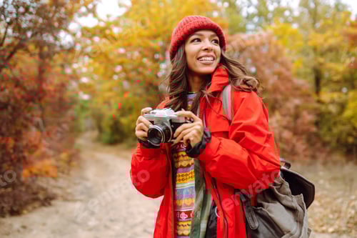 Preview: Smiling woman enjoying autumn weather. Rest, relaxation, lifestyle concept.