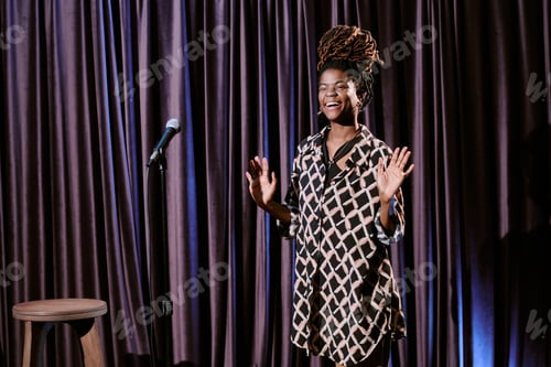 Preview: Smiling Performer Standing on Stage During Show